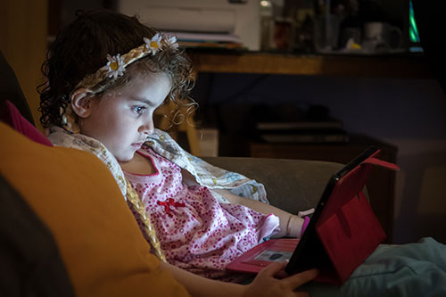 girl mesmerized by screen