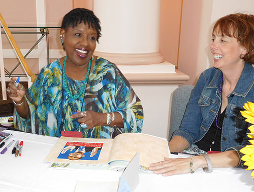 Nikki Grimes autographing books